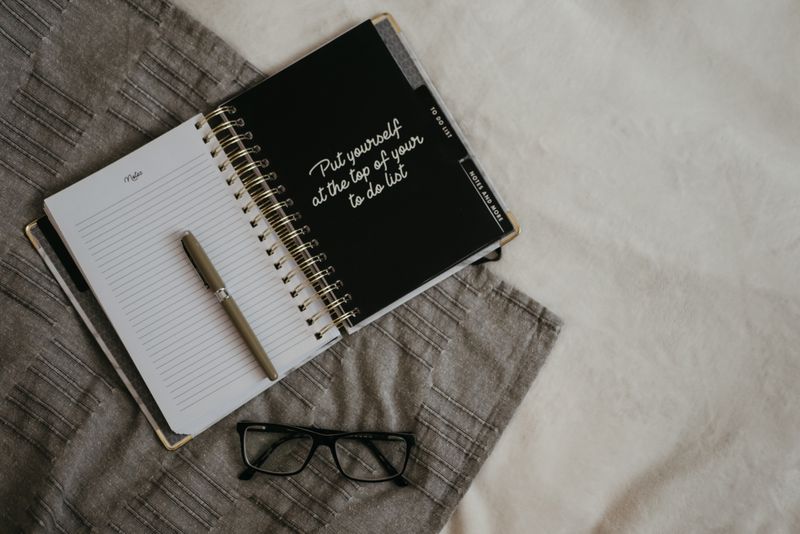 Styled planner and pen flat lay on a neutral surface