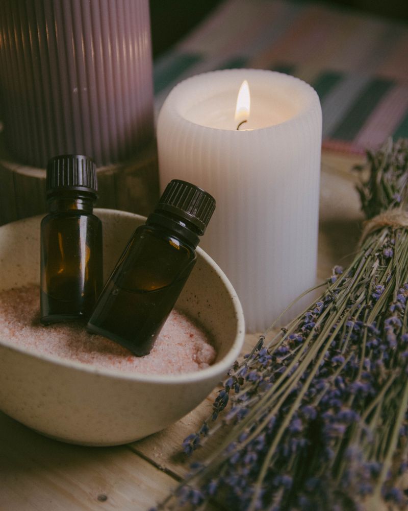 Botanical oils, candles and lavender arranged together