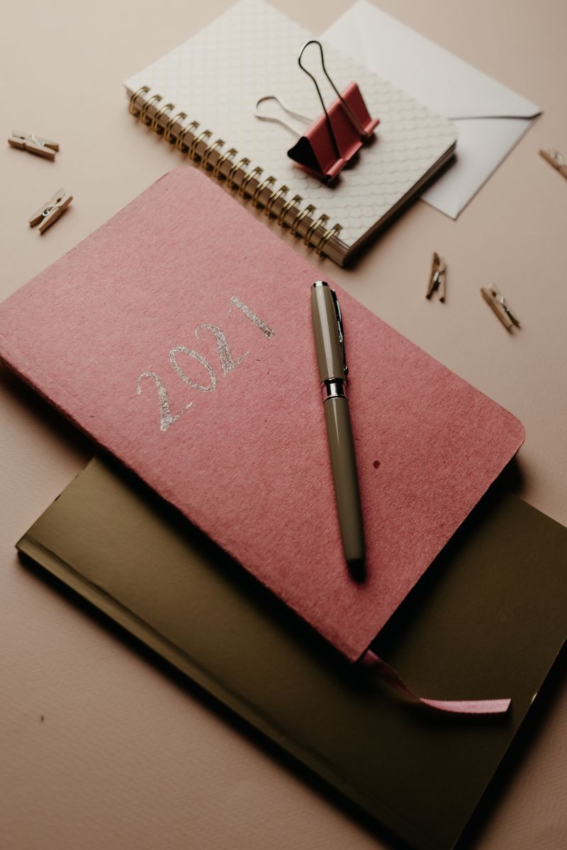 Luxury linen planner and notebooks styled on a desk
