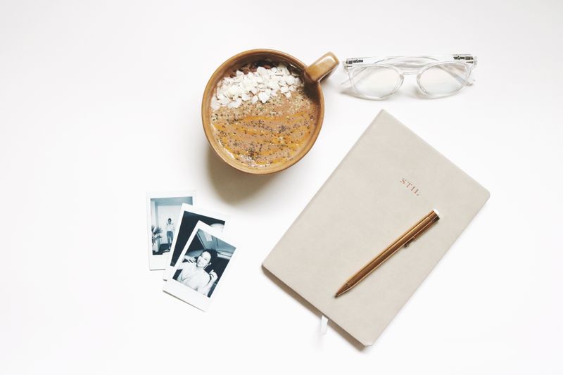 Notebook, coffee and eyeglasses on a desk